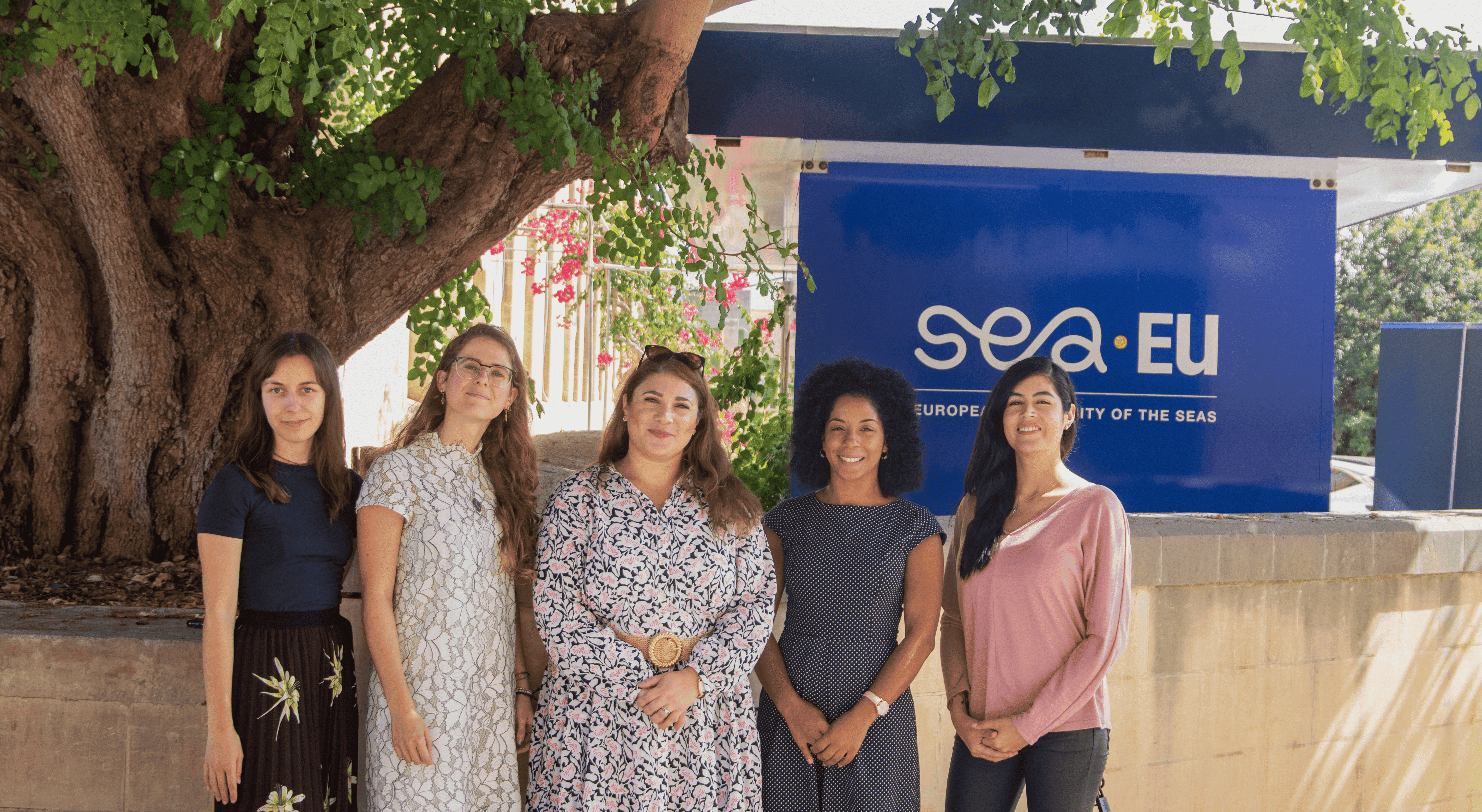 5 women standing in front of the SEA-EU Hut