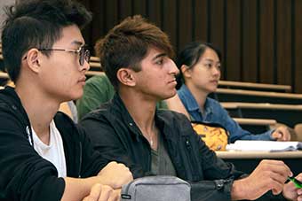 Three international students during a lecture