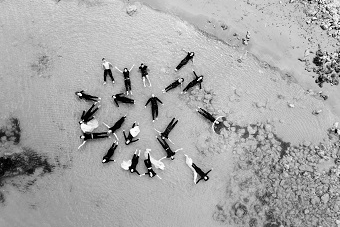 An aerial picture of people lying flat on the sand