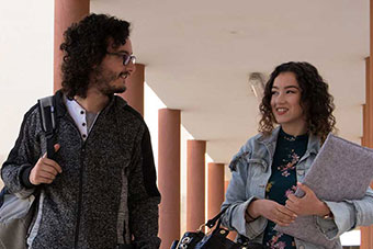 Two students walking along at the University of Malta Msida Campus